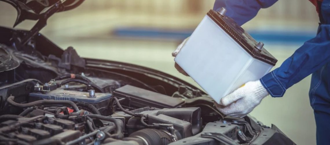 technician or auto mechanic change the car battery in auto repair car service center.